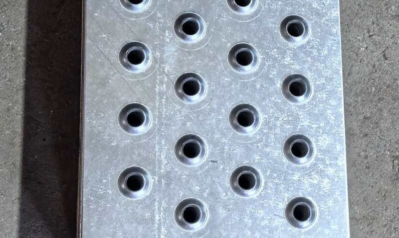 Cross-section of raised perforated grating holes for slip resistance