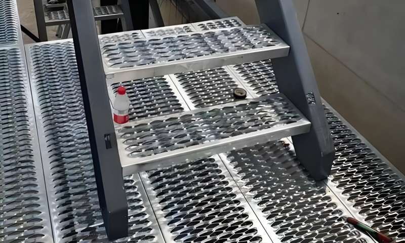 Industrial walkway with perforated safety grating flooring