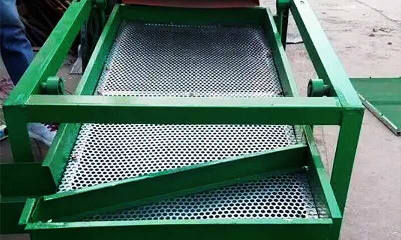 Q355B perforated steel guard on industrial machinery.